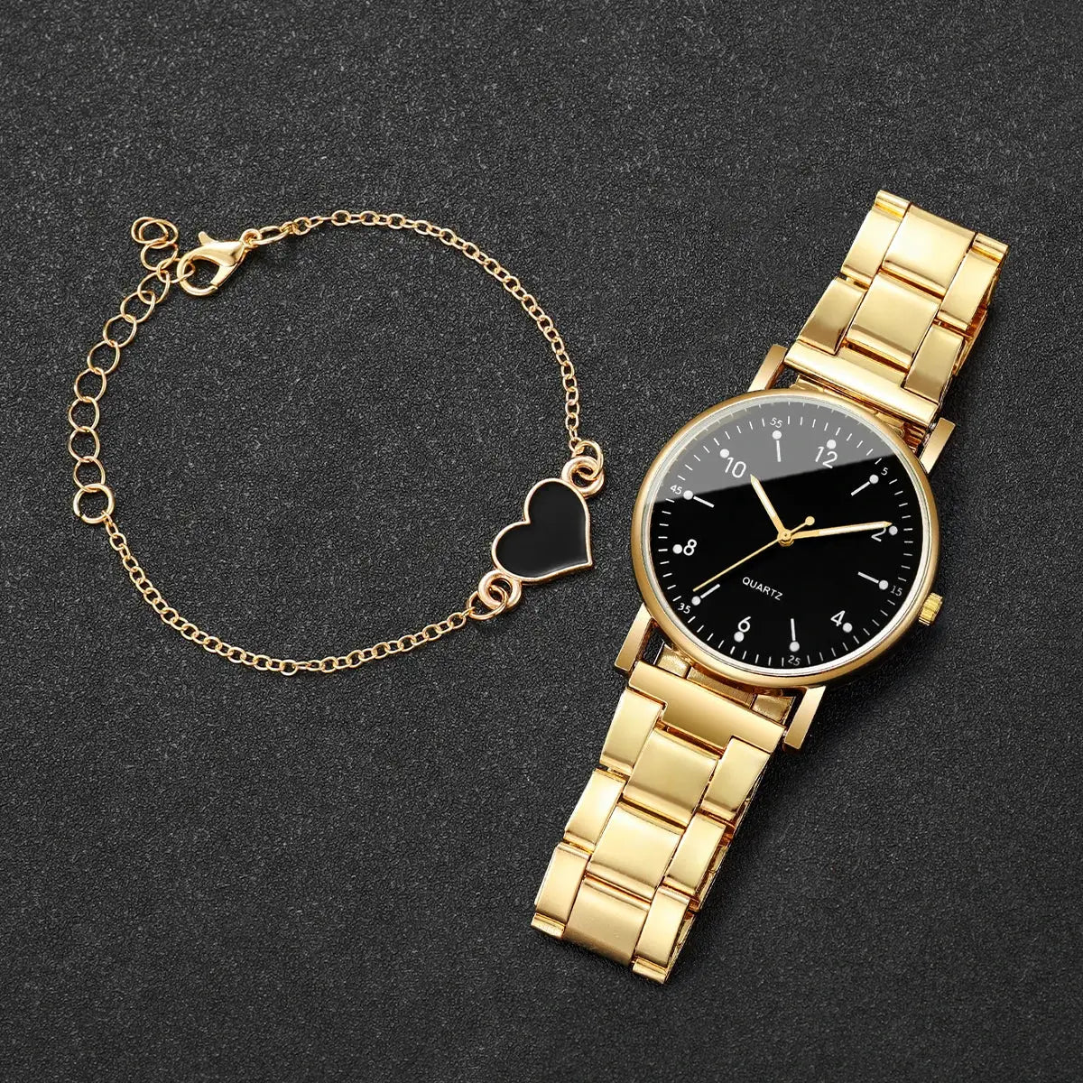 Gold-tone women's quartz watch with black Arabic dial and matching gold bracelet with heart charm (2-piece set)