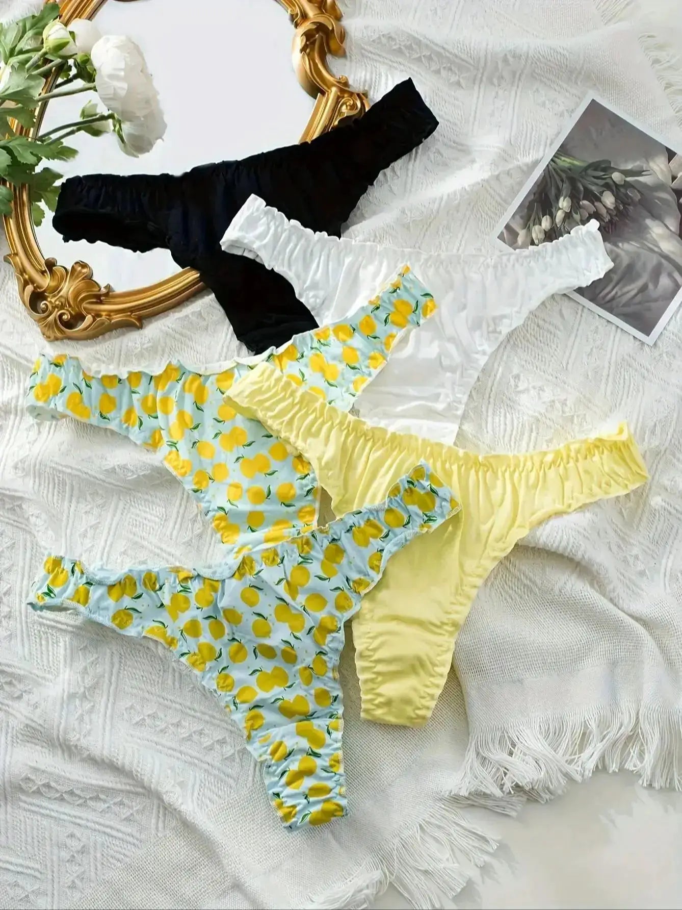 5-piece cotton women’s thong set with fruit pattern and ruffled waistbands; white, black, lemon-print blue, and pastel yellow