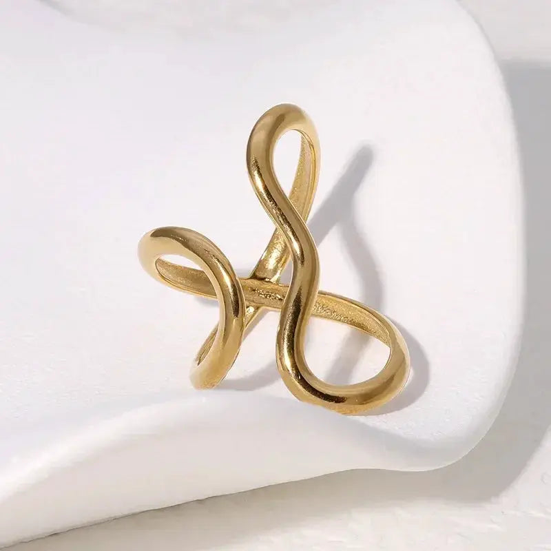 Gold-tone stainless steel ring with irregular twisted loops; unisex fashion jewelry.