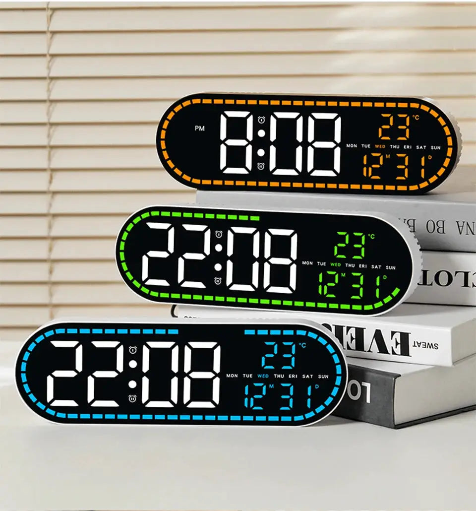 Digital LED wall clocks: three units with orange, green and blue borders showing time, date and temperature, two alarms.