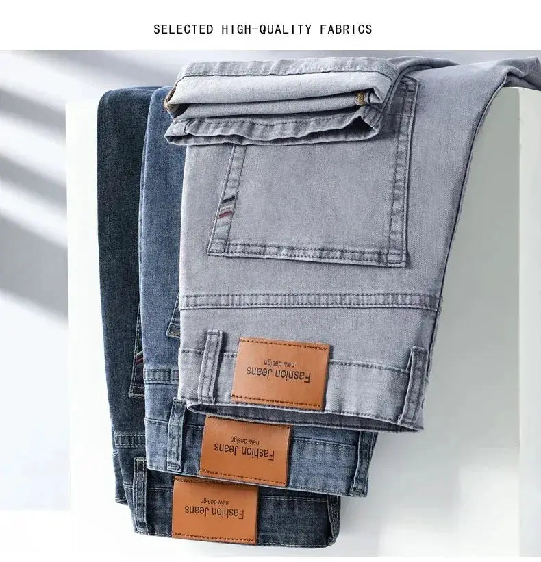 Men's denim jeans four-pair stack in gray and blue with brown leather patches.