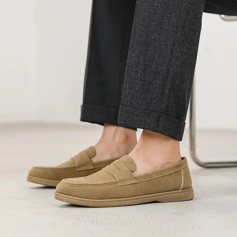 Men's tan suede slip-on loafers with penny strap and light sole