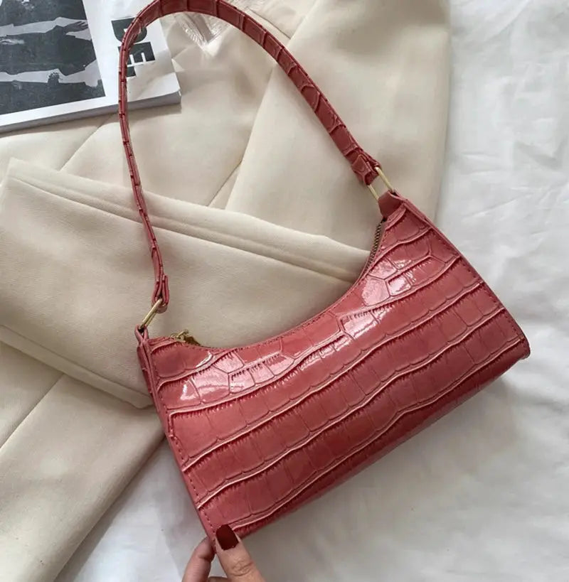 Alligator-pattern PU leather handbag in pink with gold-tone hardware and shoulder strap