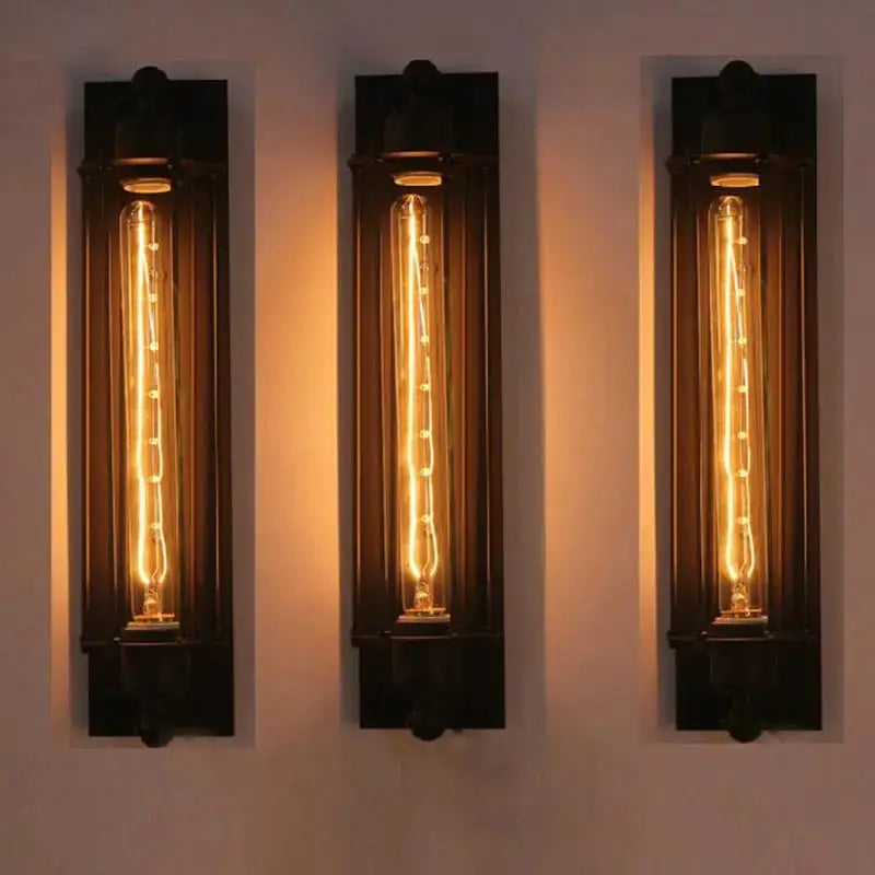 Set of three retro industrial iron wall lights with vertical LED filament bulbs for hallway or loft decor