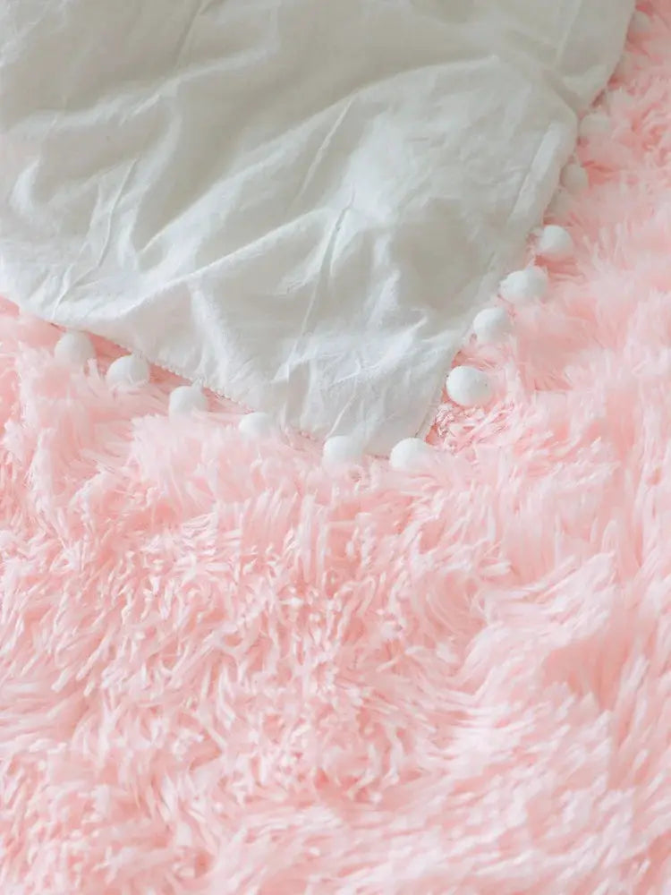 Kids fluffy pink rug with white pom-pom edging for bedroom or living room