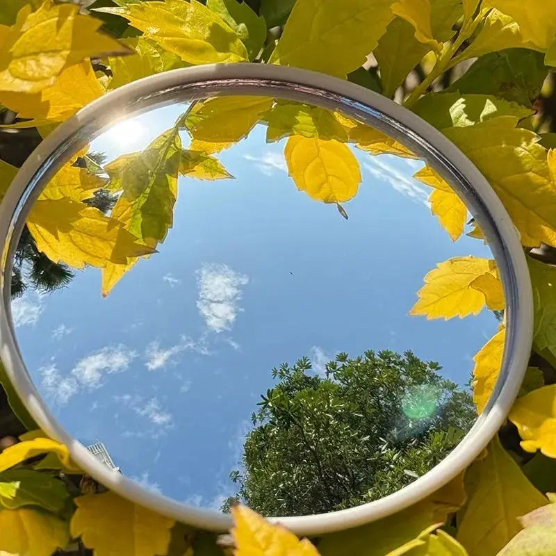 Simples Market travel handheld round mirror with silver frame reflecting blue sky and autumn leaves