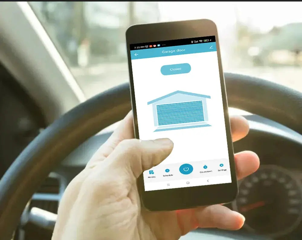 Smart garage door opener controller app on smartphone held in a car, blue UI with garage icon