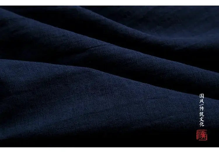 Men's Hanfu vest in dark navy linen-cotton fabric, folded to show white vertical Chinese script and a red seal