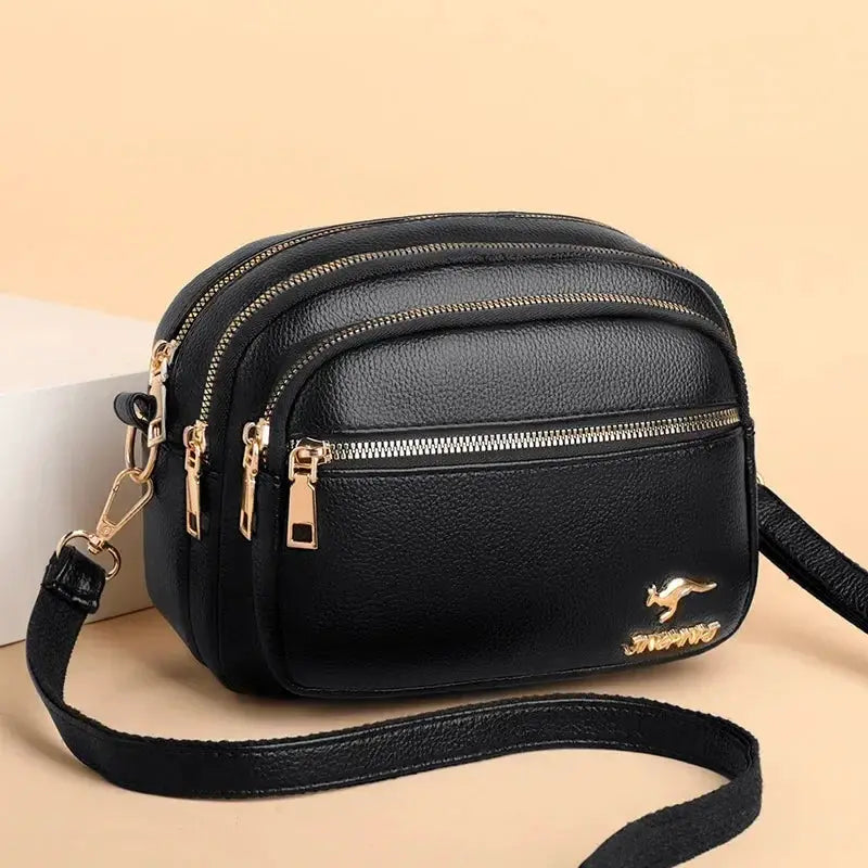 Simples Market black leather shoulder bag with multiple zip pockets and gold-tone hardware
