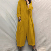 Mustard yellow women's jumpsuit with pockets, long sleeves, button-front, loose fit.