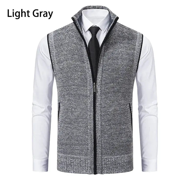 Men's light gray knitted sleeveless zip-up cardigan vest with stand collar, worn over a white shirt.