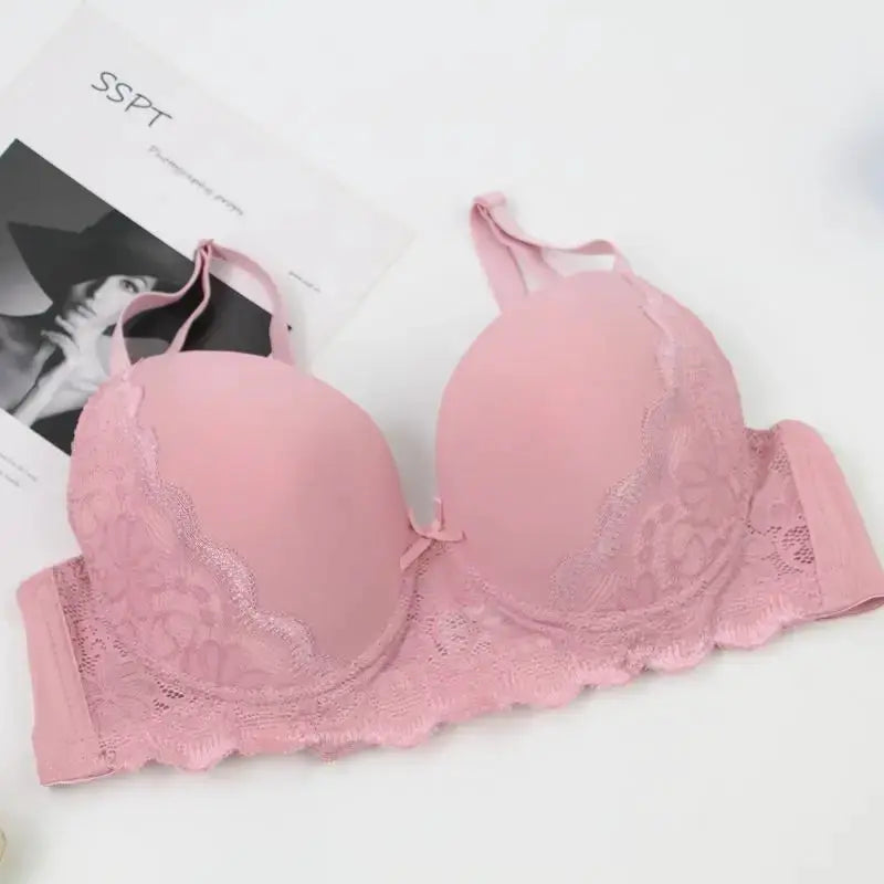 Pink lace push-up bra with scalloped floral lace, molded cups, and adjustable straps