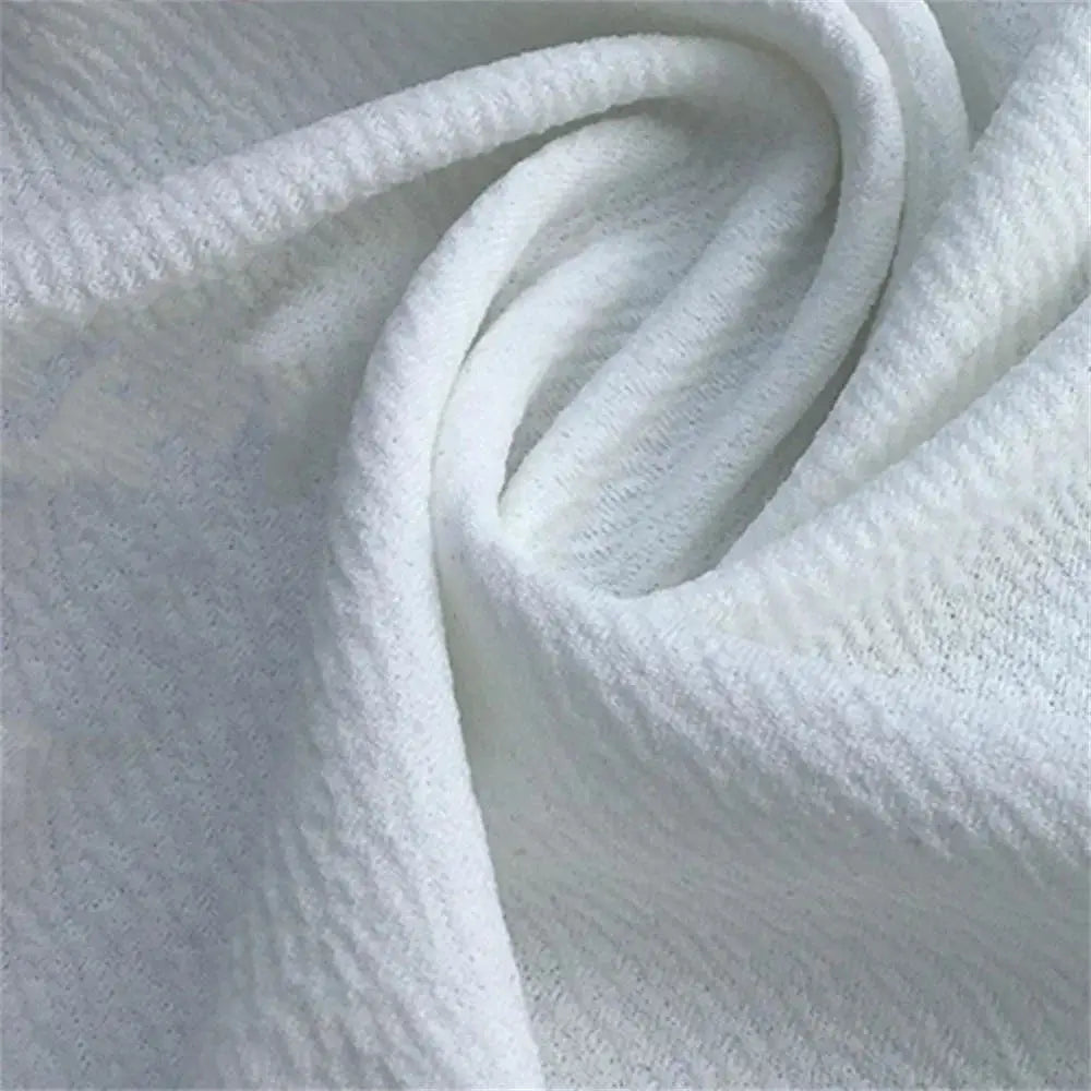 Men's shorts fabric close-up in white; soft terry-like texture