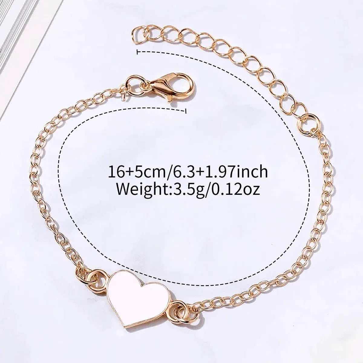 Bracelet with rose gold heart charm, linked chain, and lobster clasp