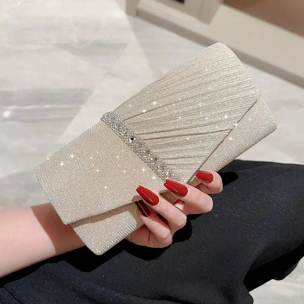 Sequin clutch purse in champagne beige with pleated envelope design and crystal band