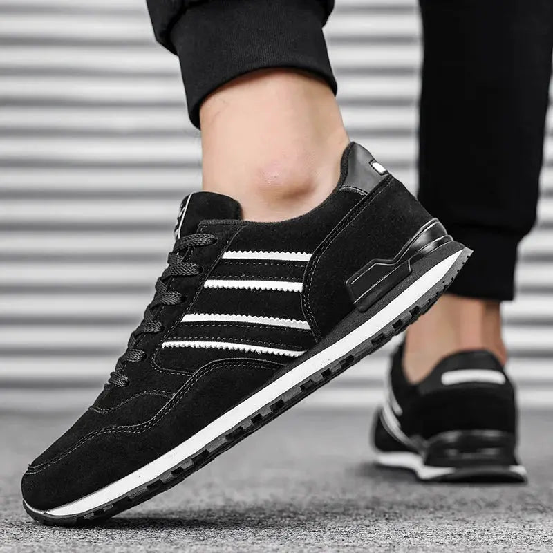 Men's black artificial leather casual sneakers with white stripes, lace-up pair
