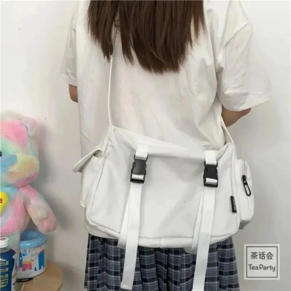 Canvas crossbody bag in white with front buckle straps, large capacity, adjustable shoulder strap