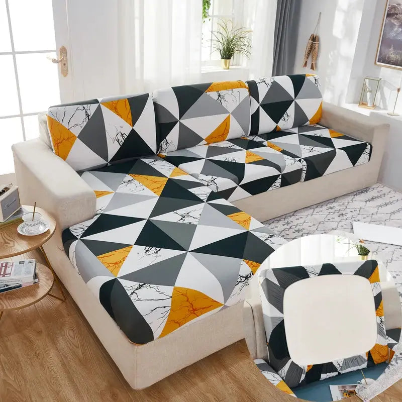 Simples Market stretch couch cushion slipcovers with gray, black, orange geometric triangles on a beige sectional sofa