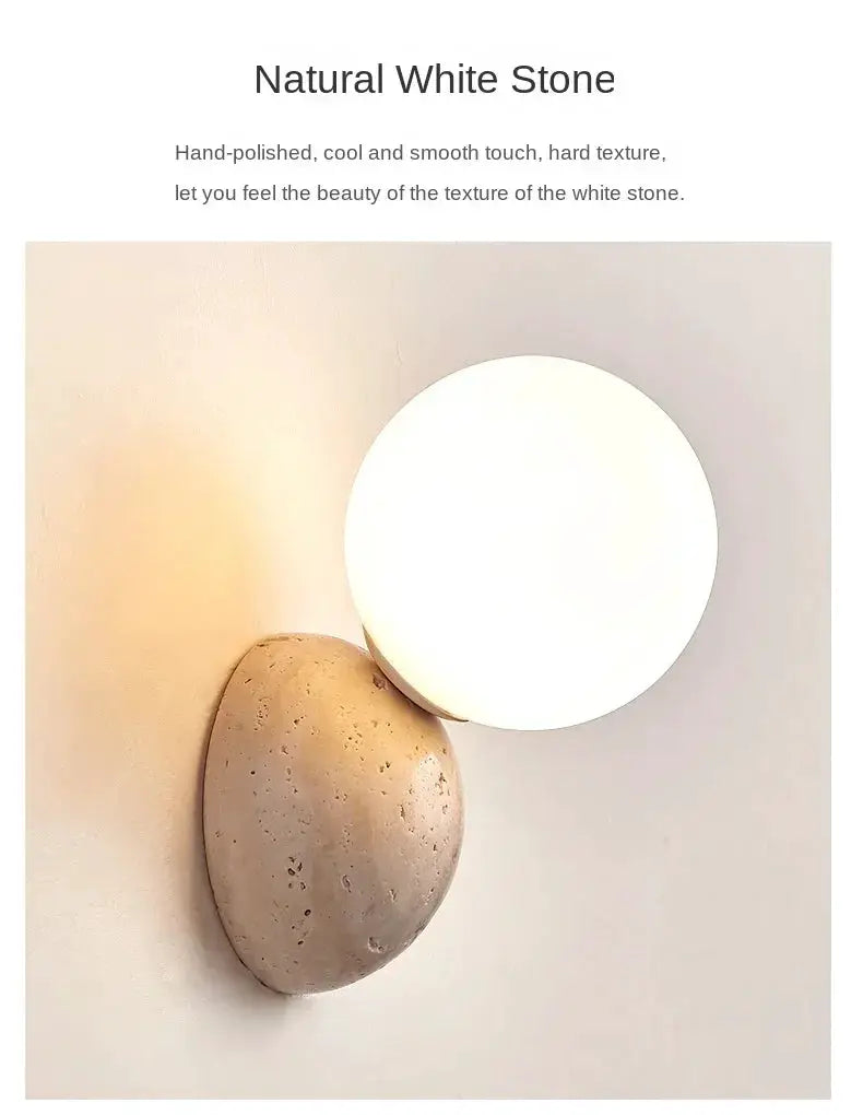 Round cream LED wall lamp mounted on natural stone wall; cave-style stone sconce for bedroom or living room.