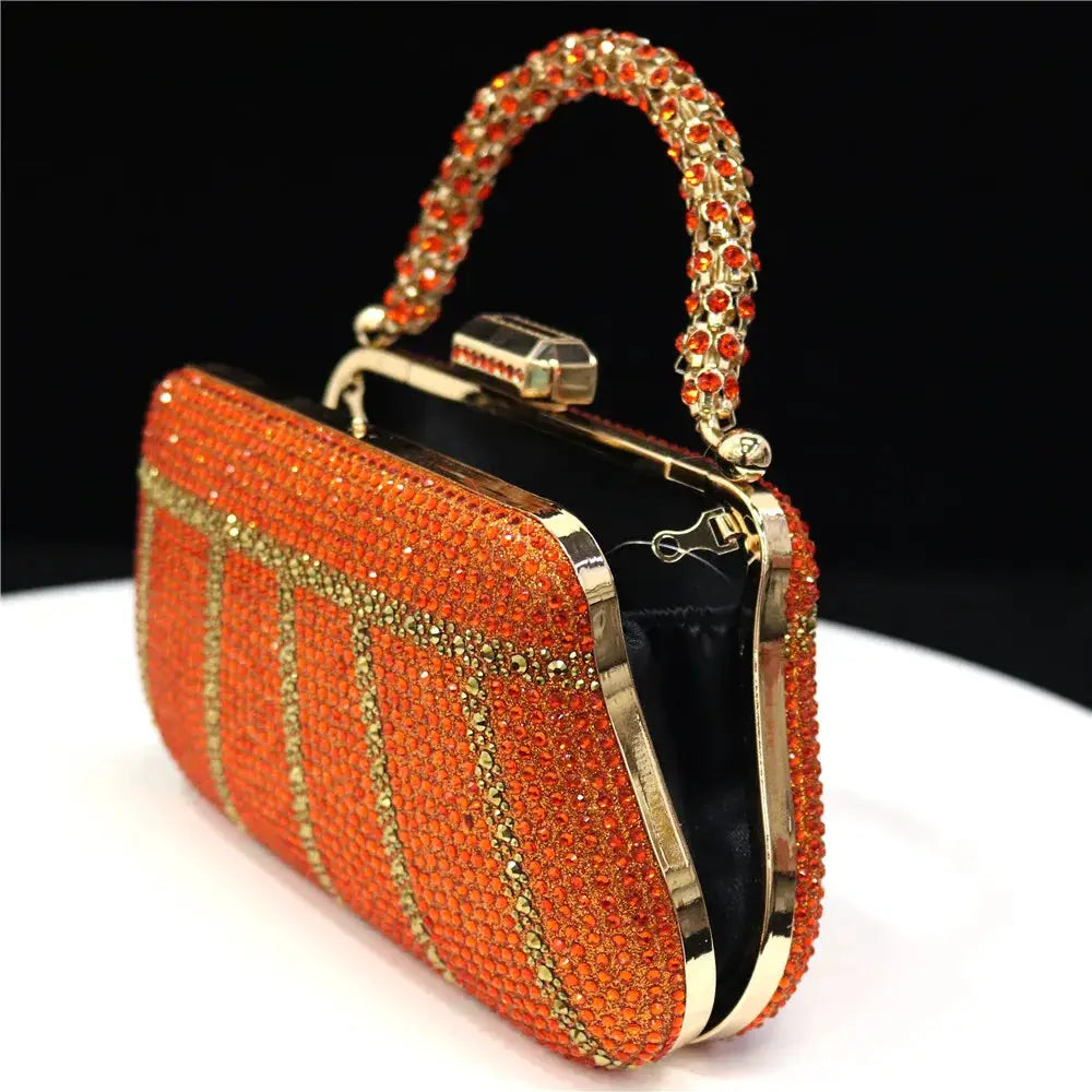Evening rhinestone clutch in orange with gold-tone frame and jeweled handle
