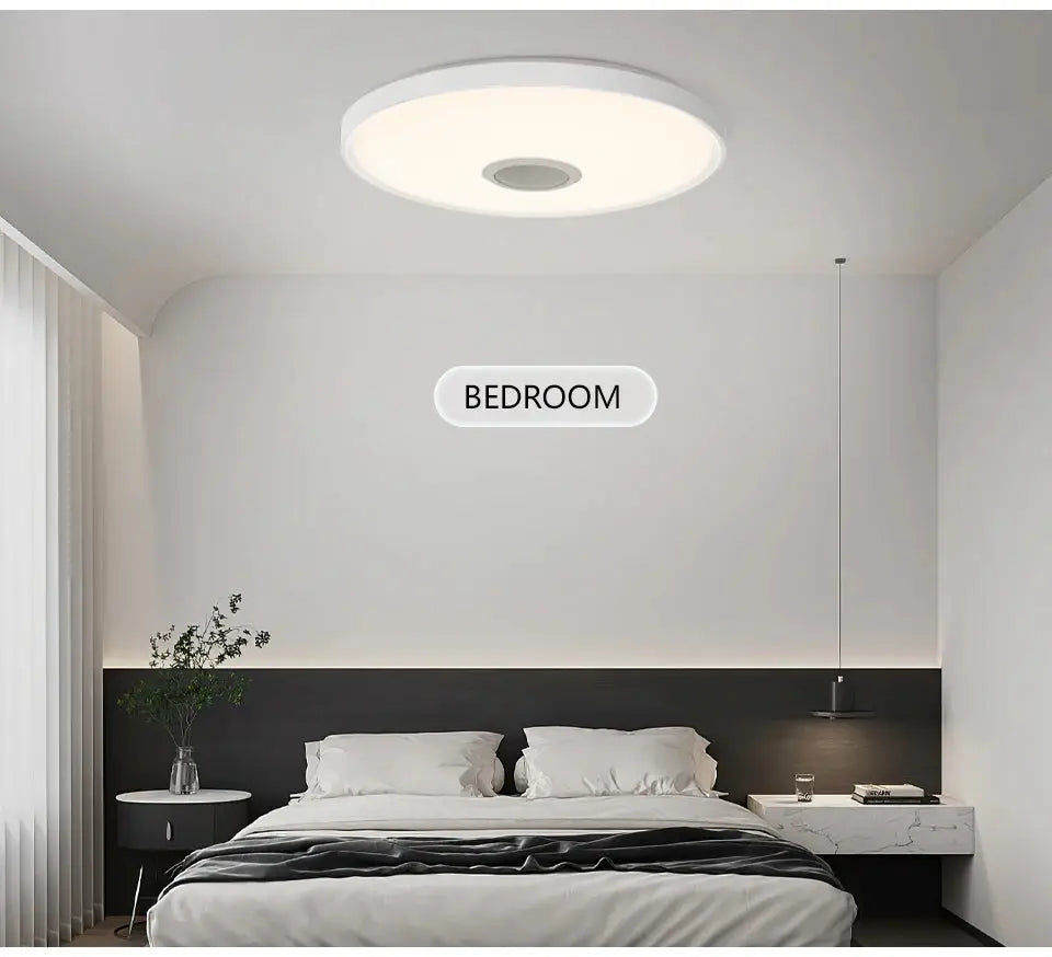 LED smart ceiling lamp RGB with APP remote control and speaker, white circular ceiling light in a modern bedroom