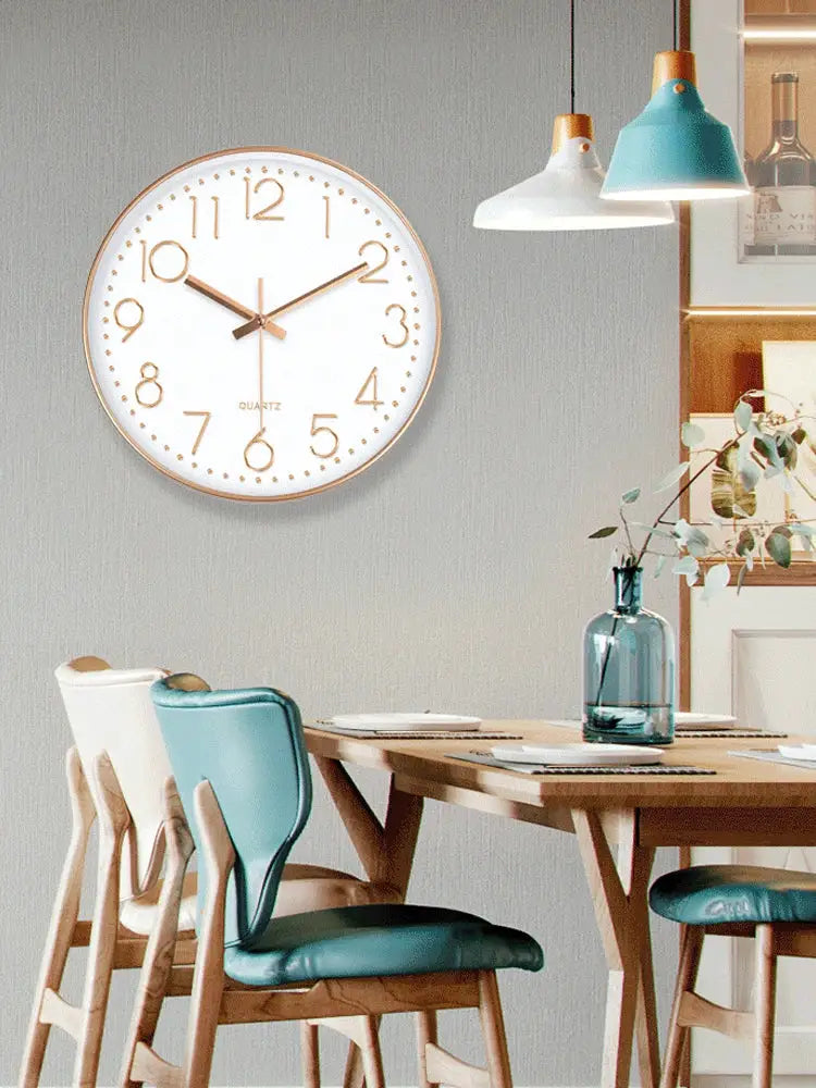 Round quartz wall clock with white face, gold numerals and hands, gold-tone frame, 8/12 inch
