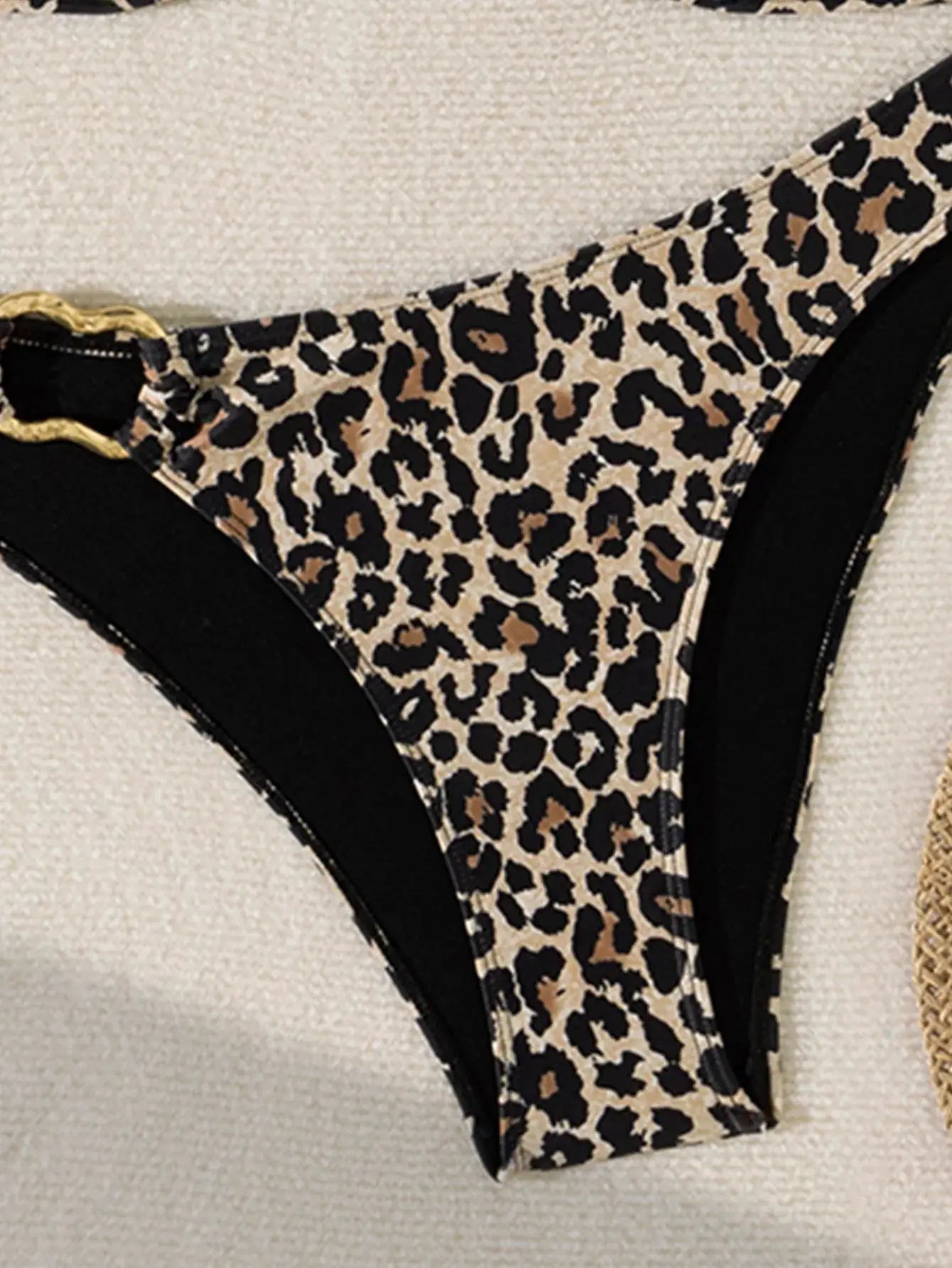 Leopard print bikini bottom with black trim and gold ring accent