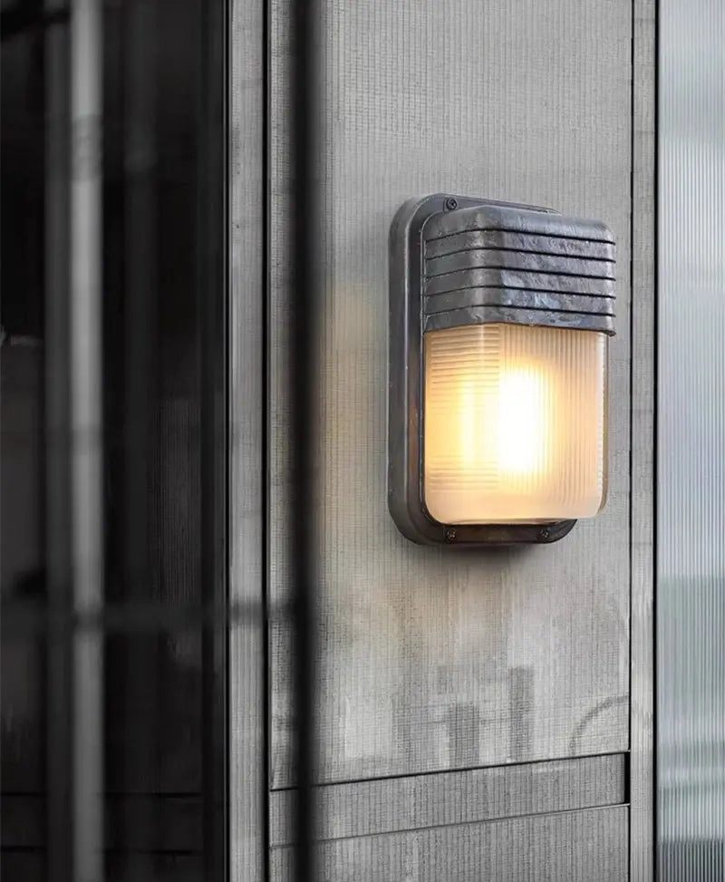 Outdoor retro LED wall lamp by Simples Market; dark metal industrial wall sconce with frosted glass diffuser IP65
