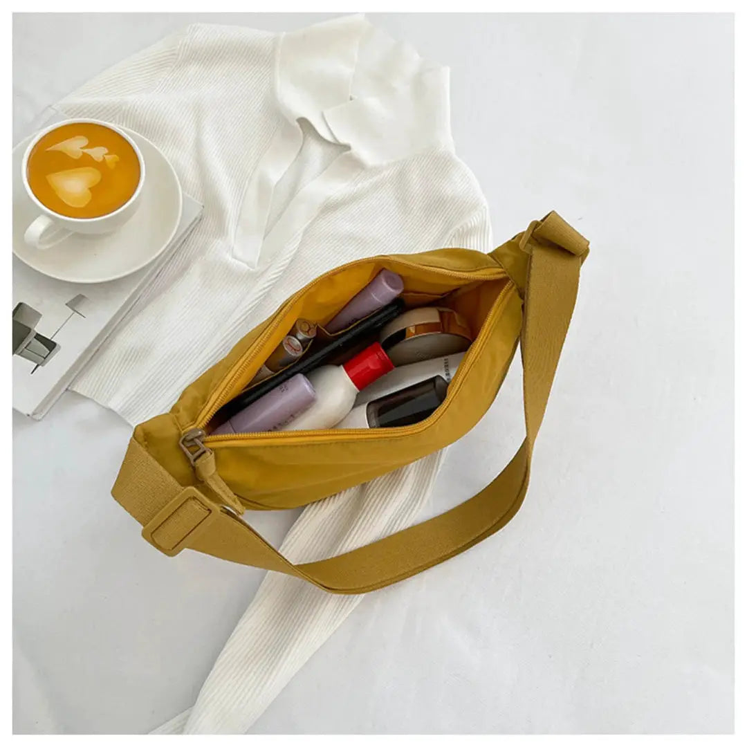 Mustard yellow nylon hobo crossbody bag for women with adjustable strap and spacious main compartment.