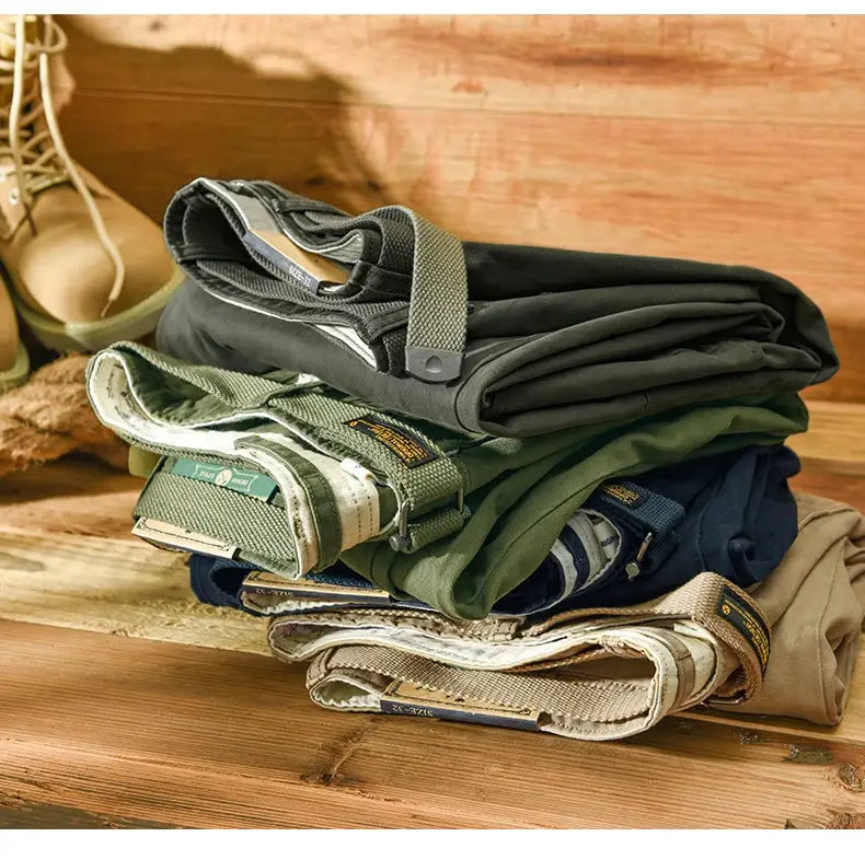 Men's cargo pants stack: 6 100% cotton loose-fit trousers in black, olive, green, navy, and beige.