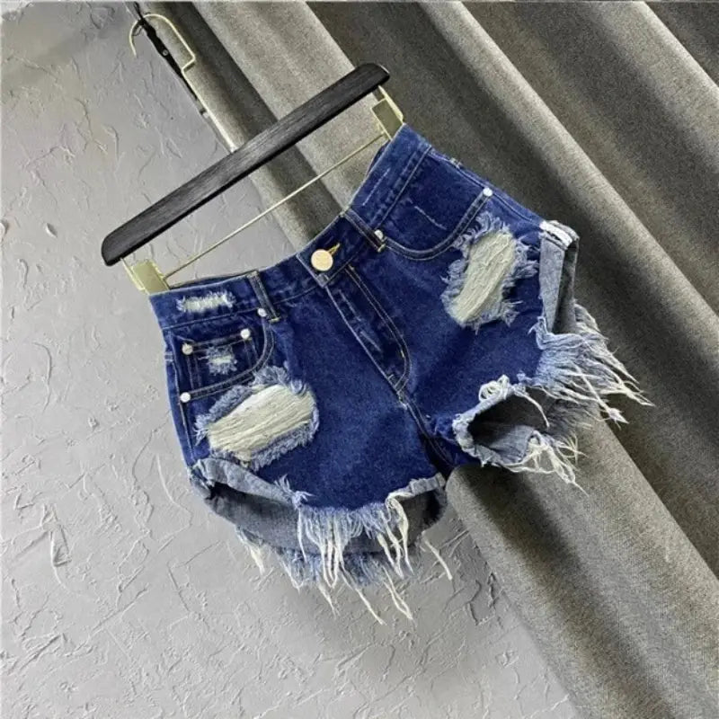 Women's denim shorts with distressed frayed edges in blue