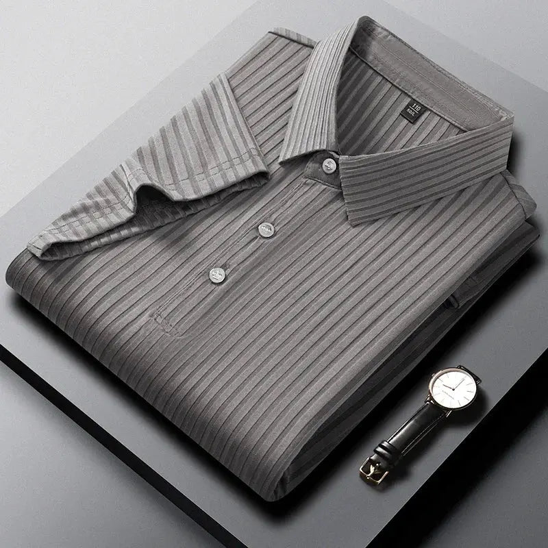 Gray striped polo shirt with collar and short sleeves, folded beside a wristwatch.