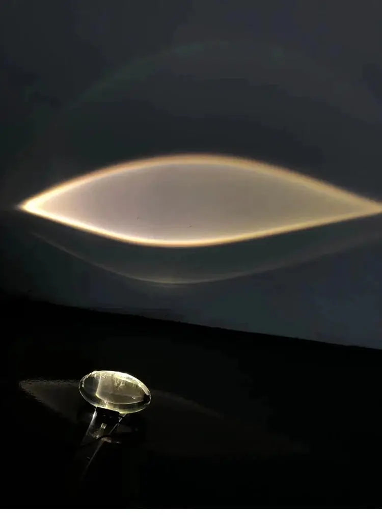 Italian designer egg-shaped LED crystal table lamp projecting a curved warm glow on the wall