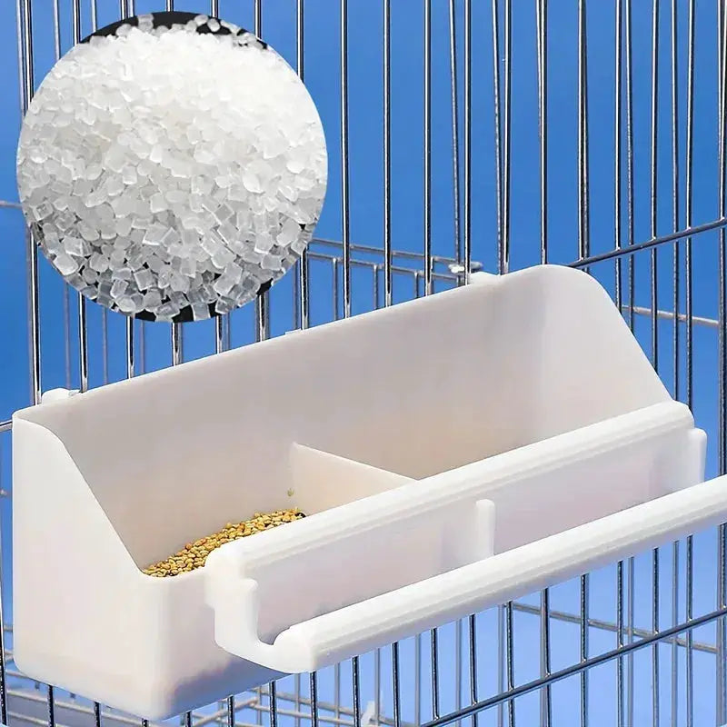 Simples Market white plastic parrot feeder trough attached to a bird cage with grain.