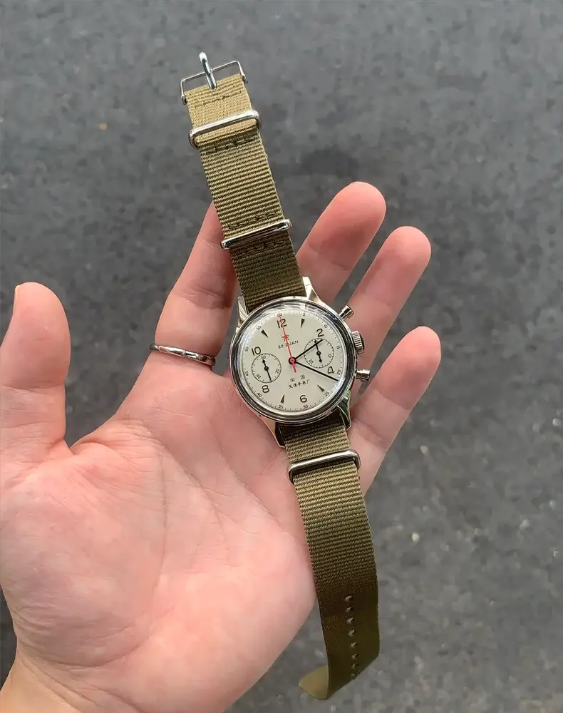 Seagull 1963 pilot chronograph wristwatch on olive nylon strap; white dial with black subdials and red seconds hand