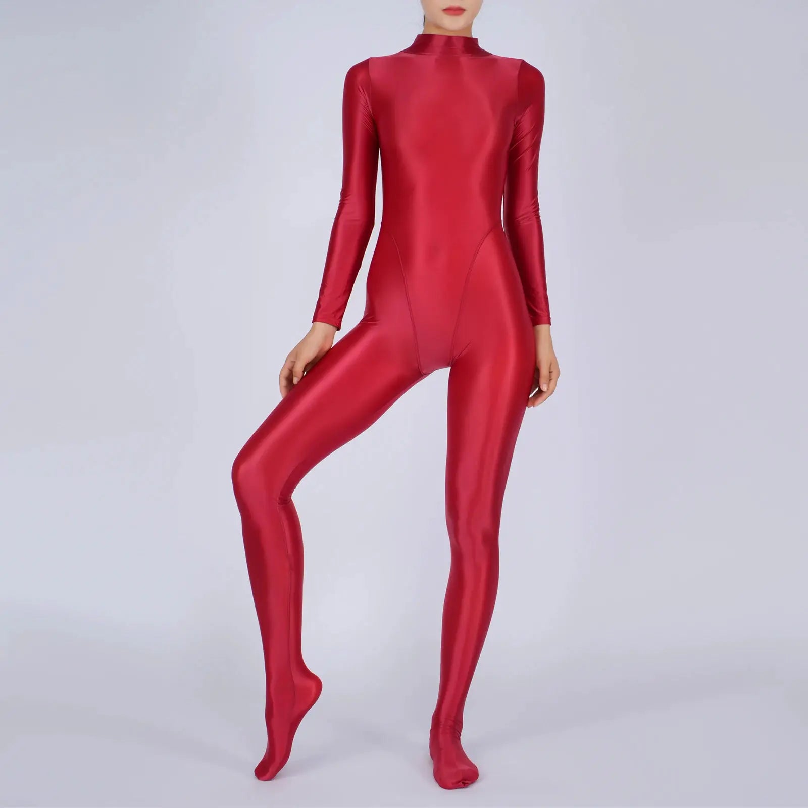 Women's red full-body jumpsuit with long sleeves and footed legs in a glossy finish