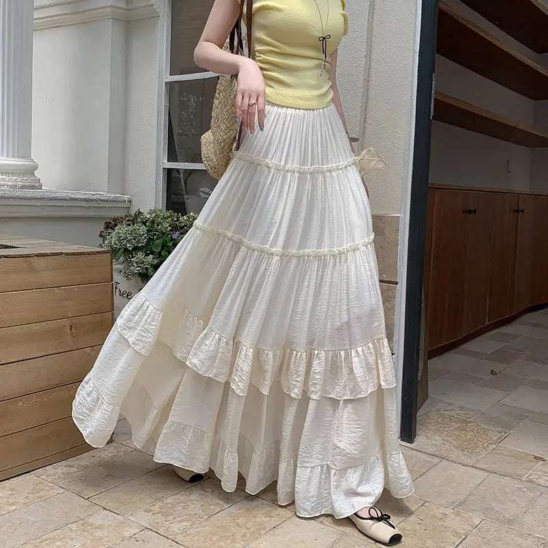 White tiered ruffle-hem maxi skirt with high waist, flowy chiffon layers