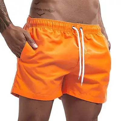 Men's orange swim trunks by Simples Market with white drawstring and pockets