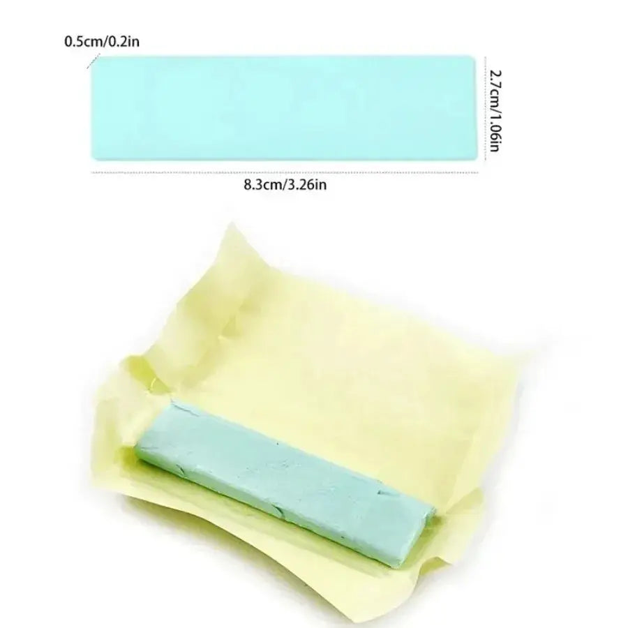 Blue rubber watch cleaning block for wristwatch care, shown with yellow wrapping as part of a watch repair kit