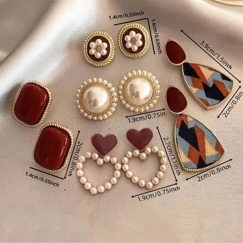 Earrings set: five pairs, Simples Market, wine-red studs, pearl halos, burgundy hearts, geometric teardrops.