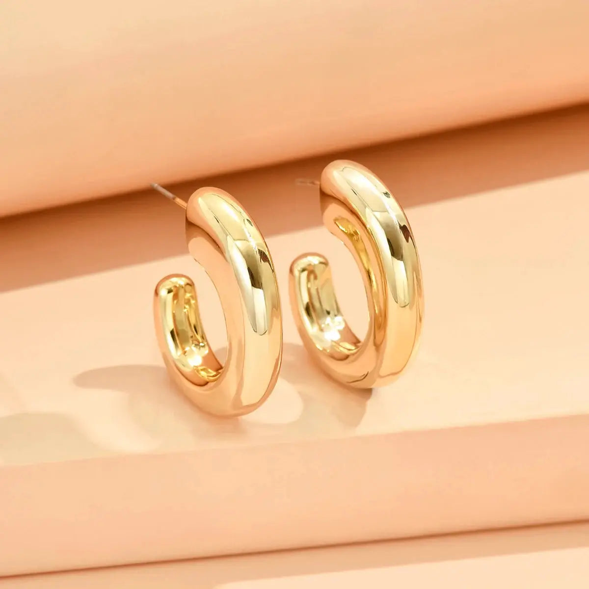 Gold-tone geometric irregular hoop earrings pair for women, minimalist style