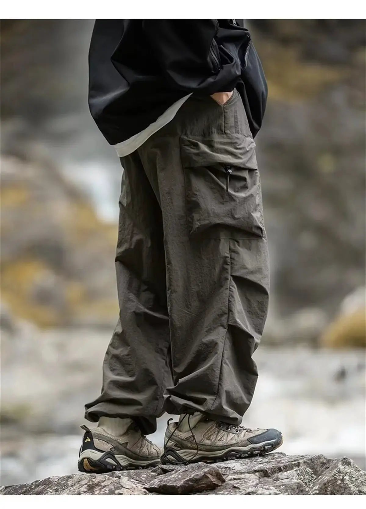 Men's waterproof mountaineering cargo pants by Simples Market in olive with zip pocket and ankle cinches.