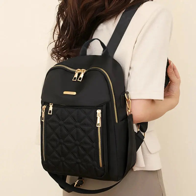 Simples Market black nylon women's backpack with diamond quilted front pocket and gold-tone zippers