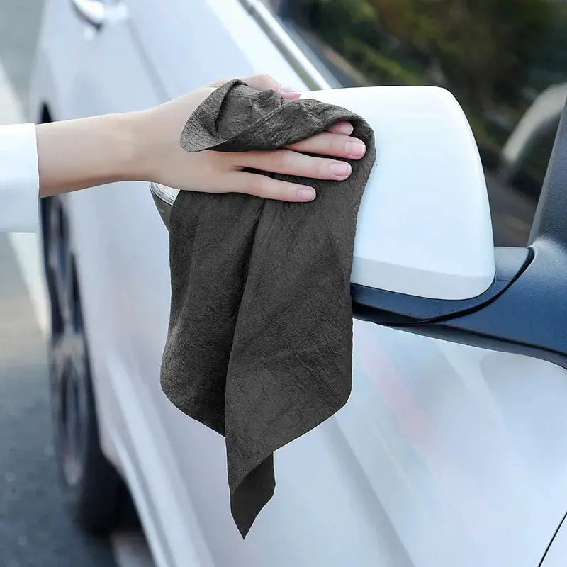 Thick microfiber cleaning cloth for wiping a car side mirror; dark gray, reusable.