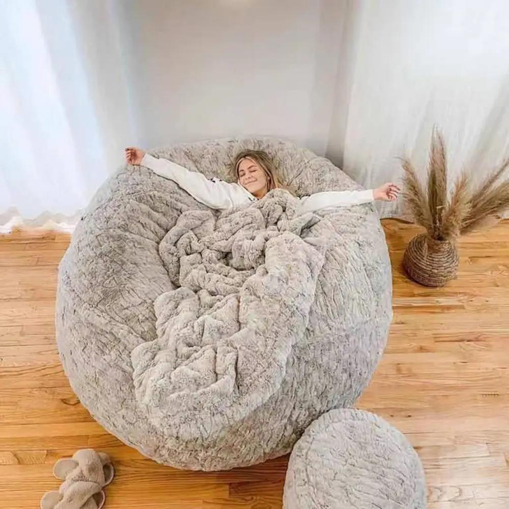 Bean bag sofa bed in gray fuzzy fabric with a matching ottoman; oversized cozy lounge seating.