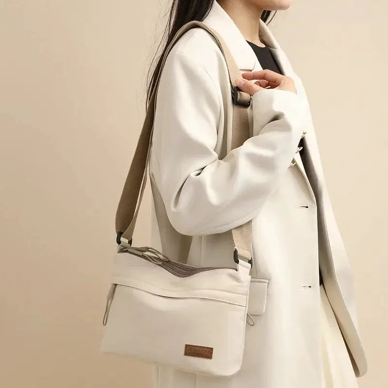 Three-pocket canvas shoulder bag by Simples Market in beige, a crossbody purse with multiple pockets