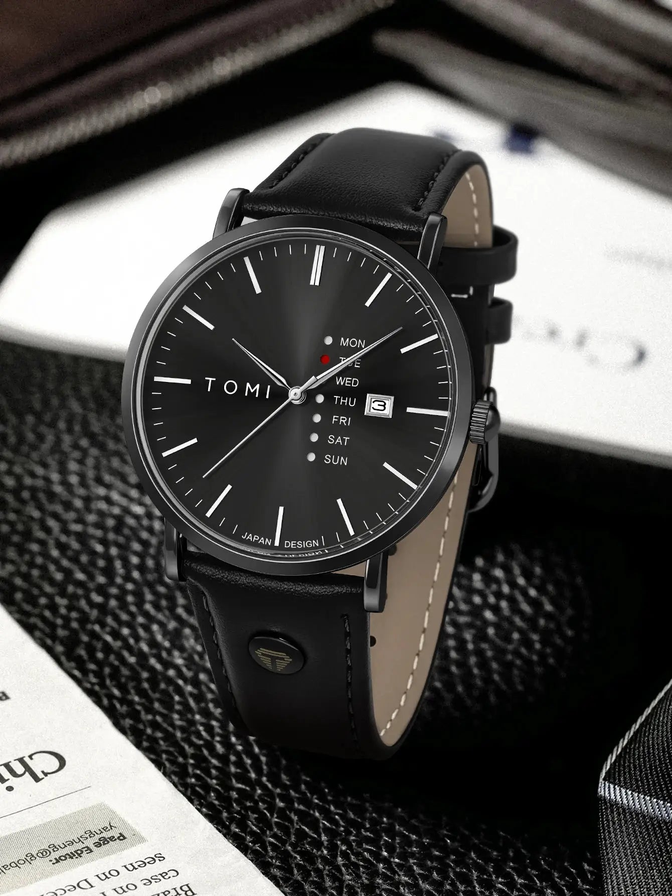 TOMI men's quartz watch with textured black dial and leather strap; weekday calendar and date display.