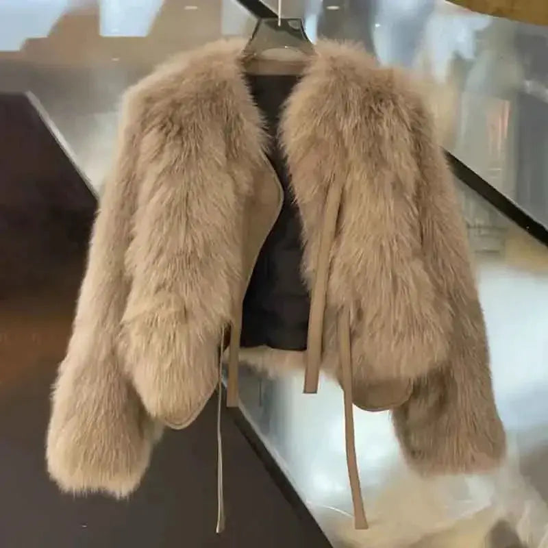 Beige women's belted faux fur coat displayed on a hanger.