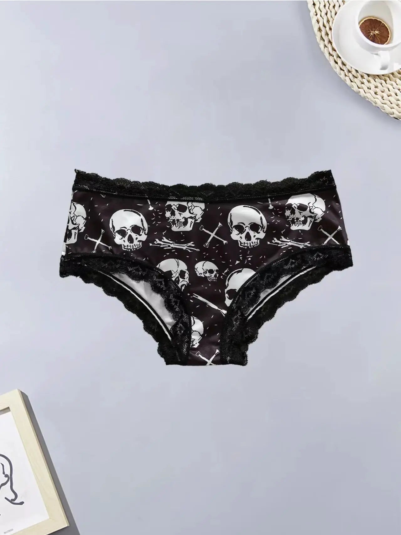Women's black skull-print lace-trim panties with a comfortable fit