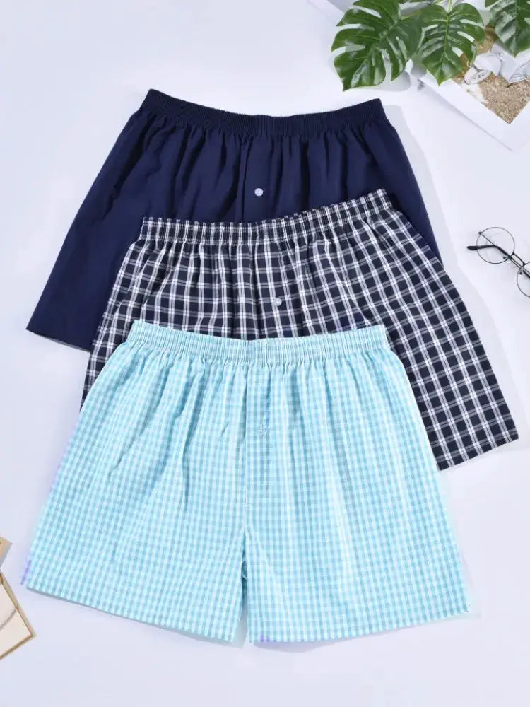 Men's cotton sleep shorts; three pairs in navy solid, navy plaid, and light blue gingham with elastic waistbands